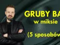 Mężczyzna w czarnej kurtce stoi przed głośnikiem. Żółty napis głosi: "GRUBY BAS w miksie (5 sposobów)".