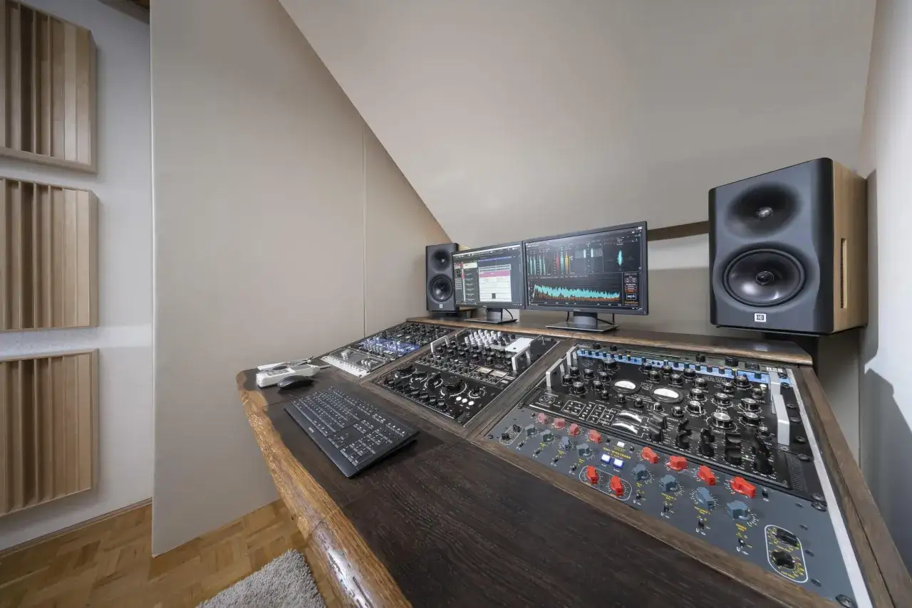 Profesjonalne, solid studio nagraniowe z konsolą, monitorami i dwoma ekranami.